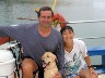 Chris and Yukiko, owners, and Hana, Security Director of Let's Dive Guam, aboard the boat