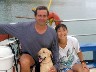 Chris and Yukiko, owners, and Hana, Security Director of Let's Dive Guam, aboard the boat