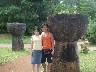 Japanese couple standing next to historic Latte Stones in Guam's capitol, Hagatna.